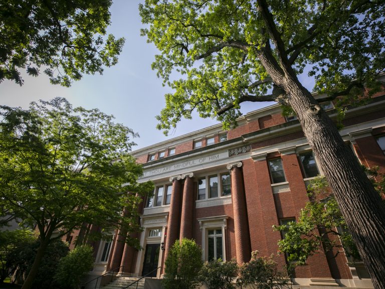 A brick building with trees in front