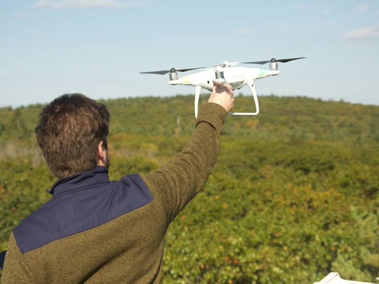 A person releasing a drone