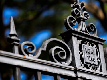 Veritas gate against blue skies.