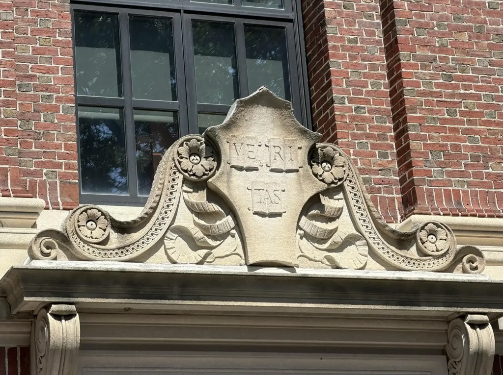 The Harvard Shield above a door