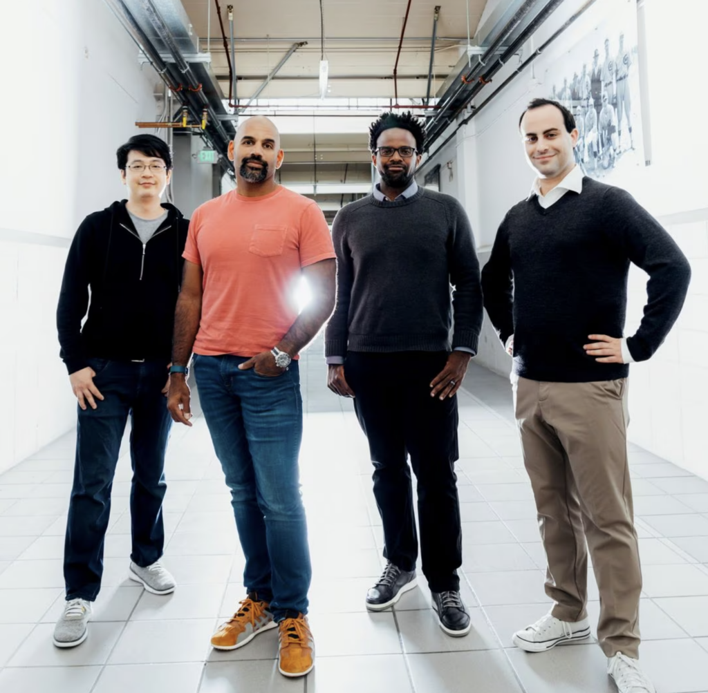 Four men standing in a line: MosaicML Chief Technology Officer Hanlin Tang, left, with CEO Naveen Rao, founding adviser Michael Carbin and Jonathan Frankle, chief scientist. 