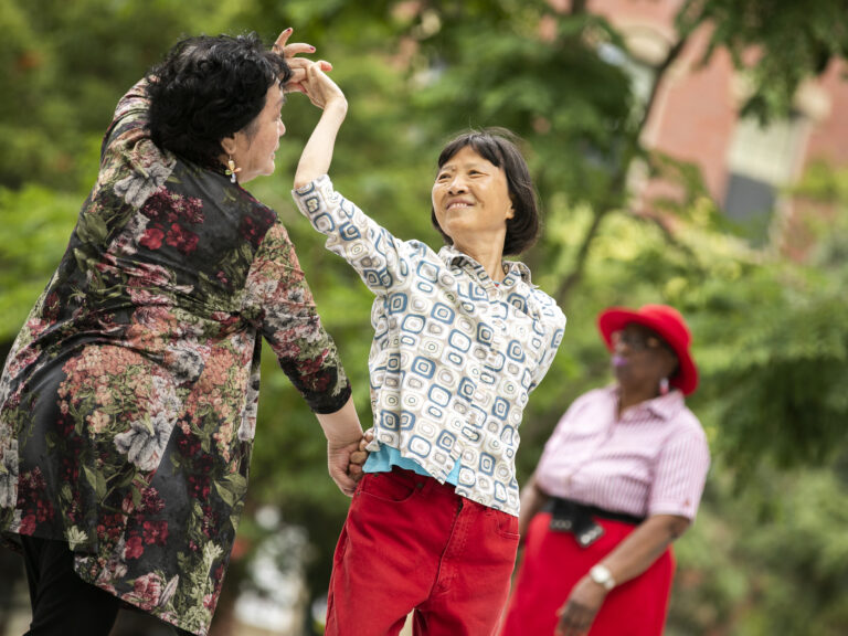Three older women dancing