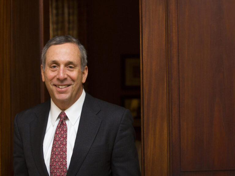 Larry Bacow leaving a room