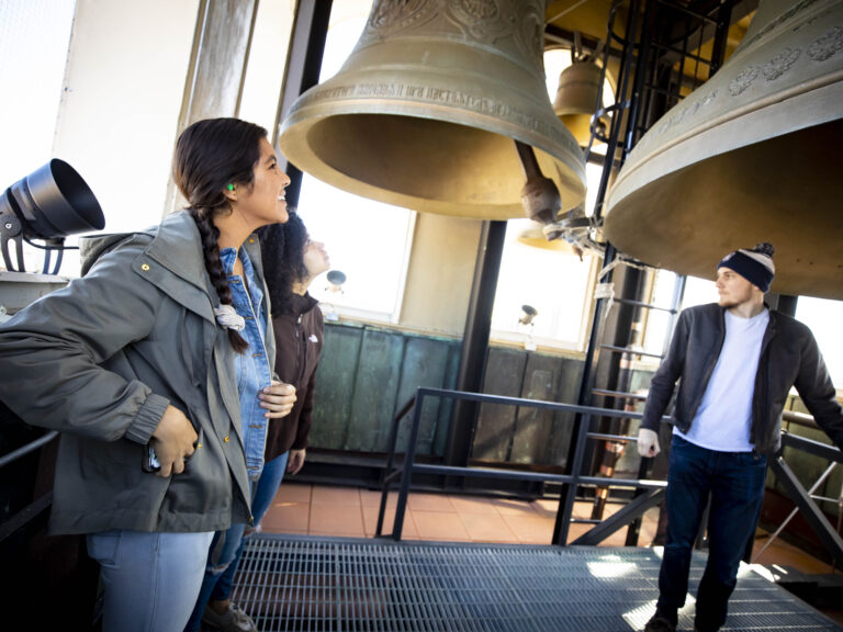 Students ringing the bells above Lowell House.