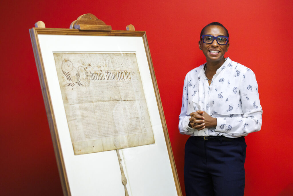 Claudine Gay poses next to the charter