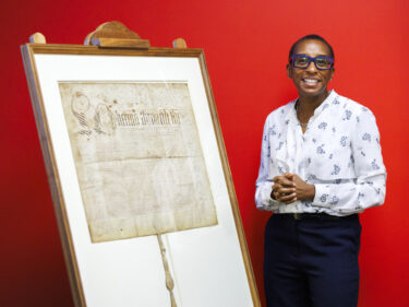 Claudine Gay poses next to the charter