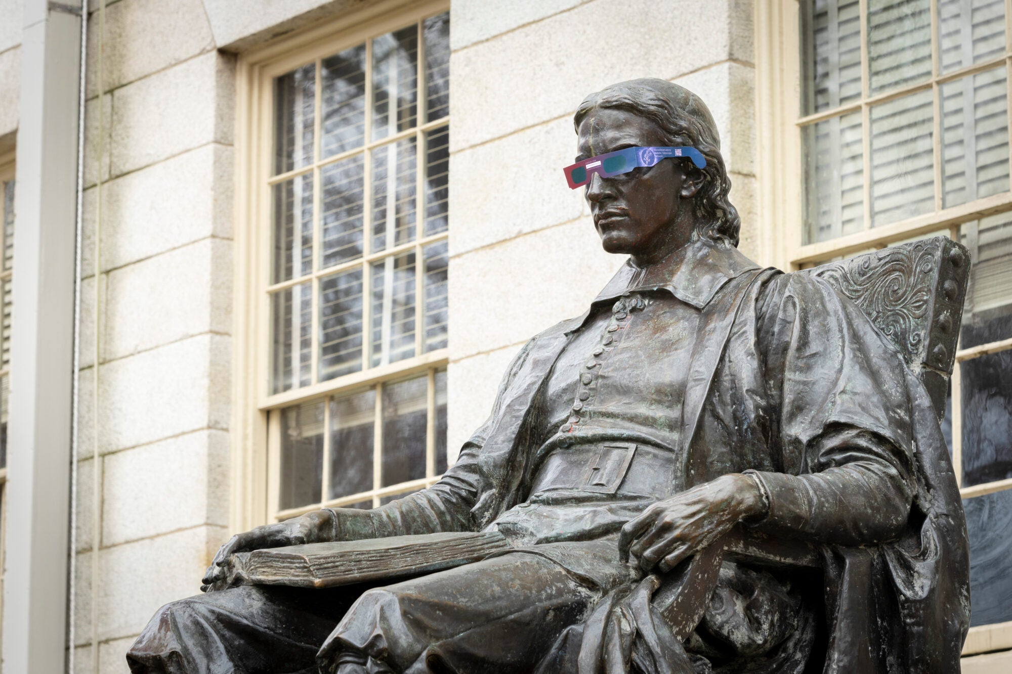 Solar glasses on the John Harvard statue.