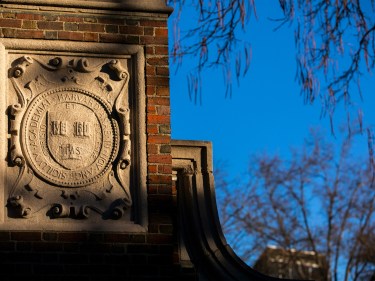 A gate with the Harvard shield