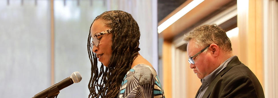 Woman speaks at a Harvard Divinity School event.