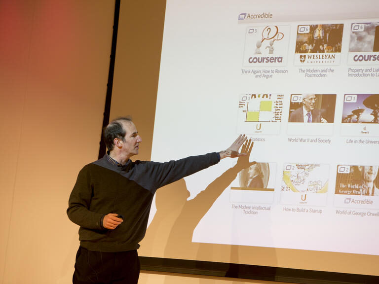 Man pointing to a powerpoint presentation screen.