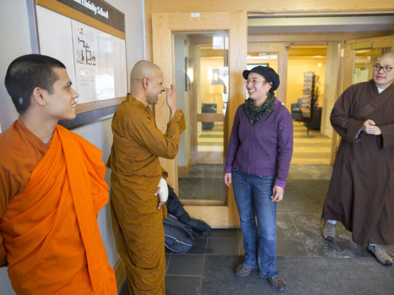 Several students dressed in various religious robes and clothing walking toward each other.