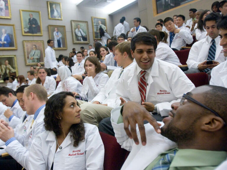 A room full of medical students in white lab coats.