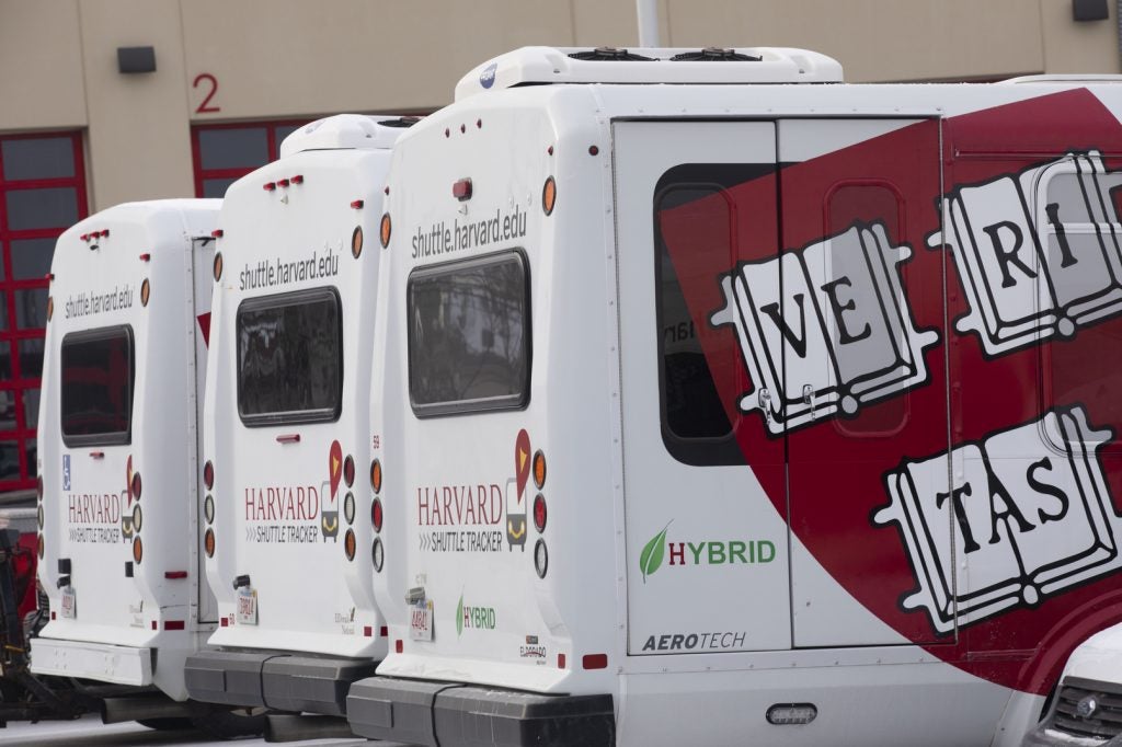 Hybrid busses with a Harvard logo