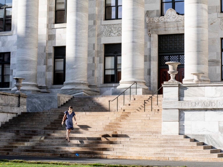 A woman walking down stairs on the HMS campus