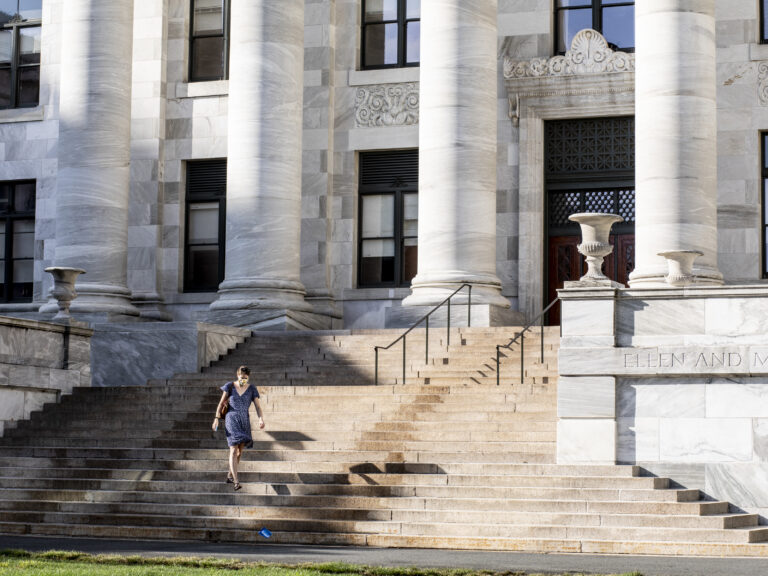 A woman walking down stairs on the HMS campus