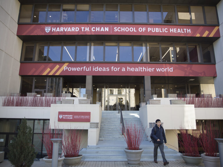 A man walking down steps on the public school campus