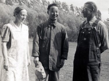 Black and white photo of two men and a woman
