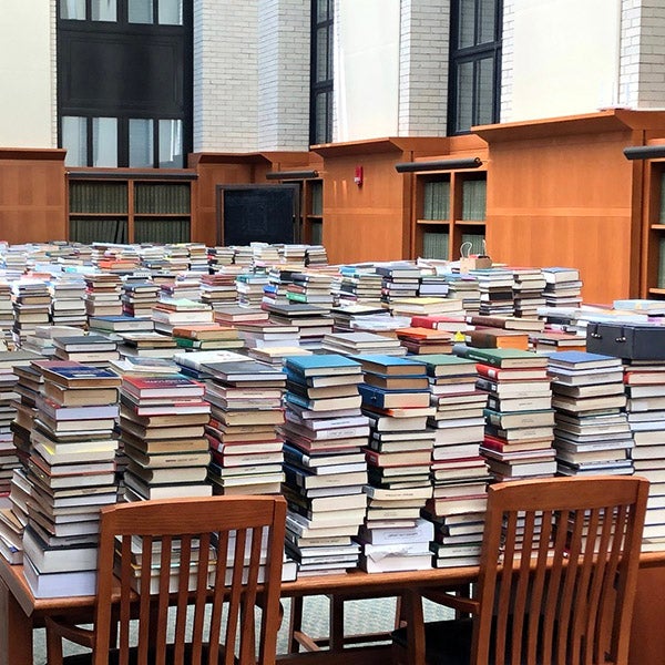 Stacks of books on tables at the library 