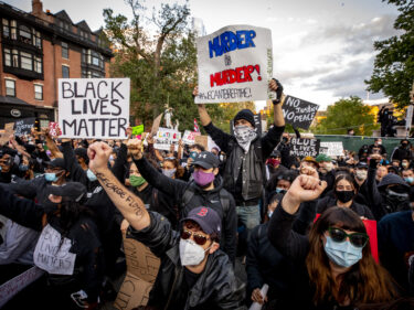 A crowd of people marching with signs