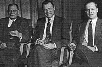 three men in suits seated.