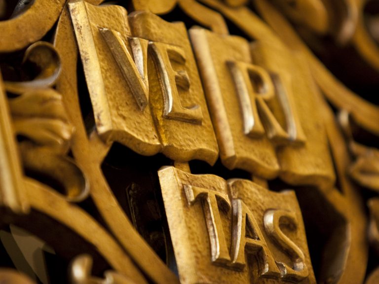 A closeup of the Veritas shield in gold