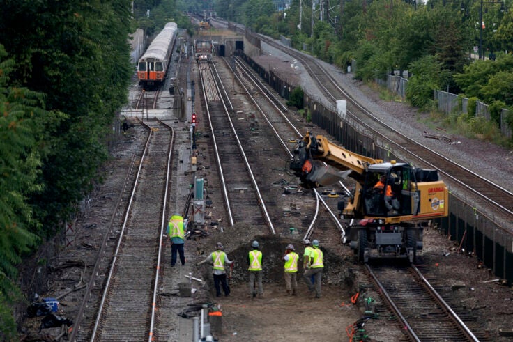 Workers remove sections of track on the Orange Line in Medford.
