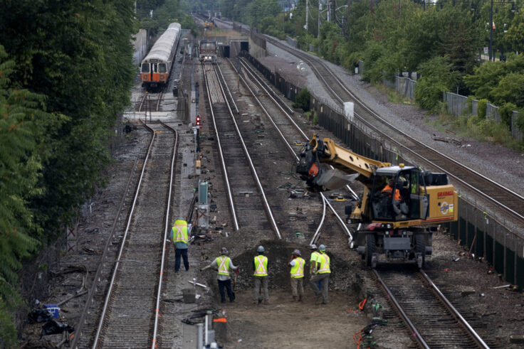 Workers remove sections of track on the Orange Line in Medford.