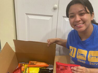 A student with a box full of donations