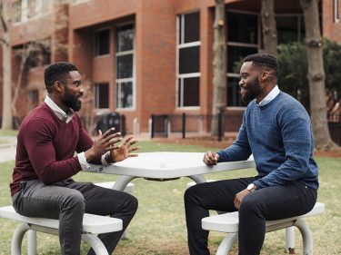 Jamaji and Onyema Nwanaji-Enwerem talking at a picnic table