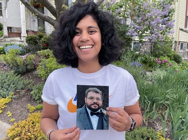 Elena Milius holding a photo of her brother