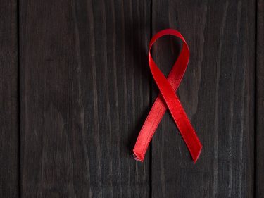 A red ribbon on wood planks