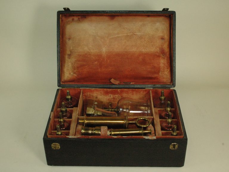 A case with glass cups and brass nobs