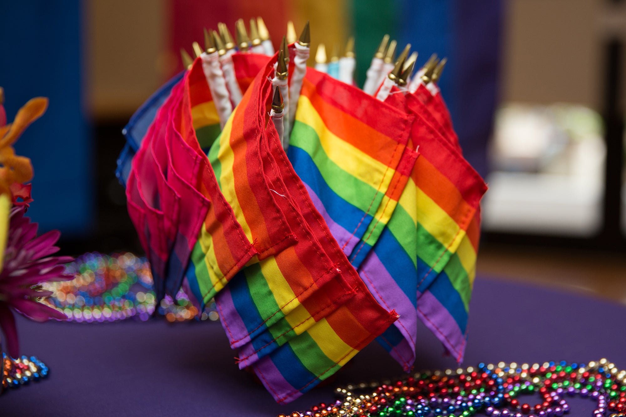 A bunch of small pride flags on a table