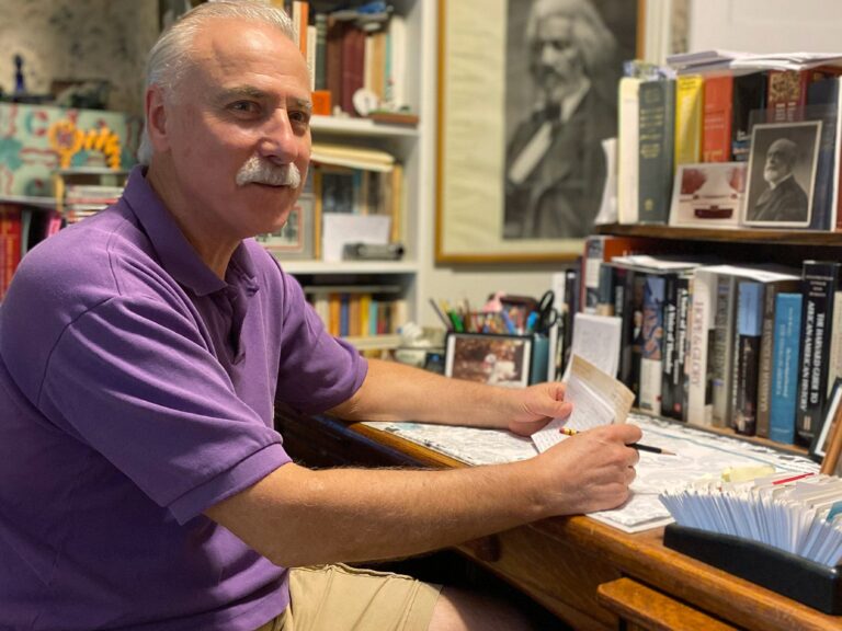 Donald Yacovone sitting at his desk
