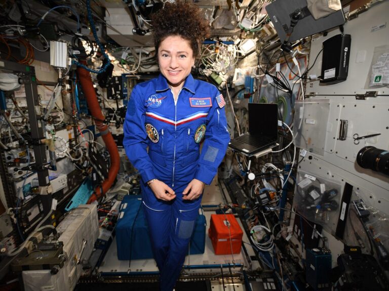 woman floating inside the space shuttle in space.