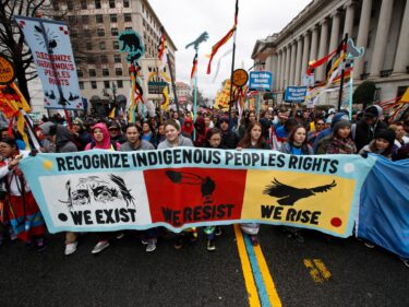 Native Americans and their supporters marching toward the White House