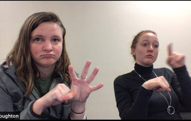 Two people doing sign language
