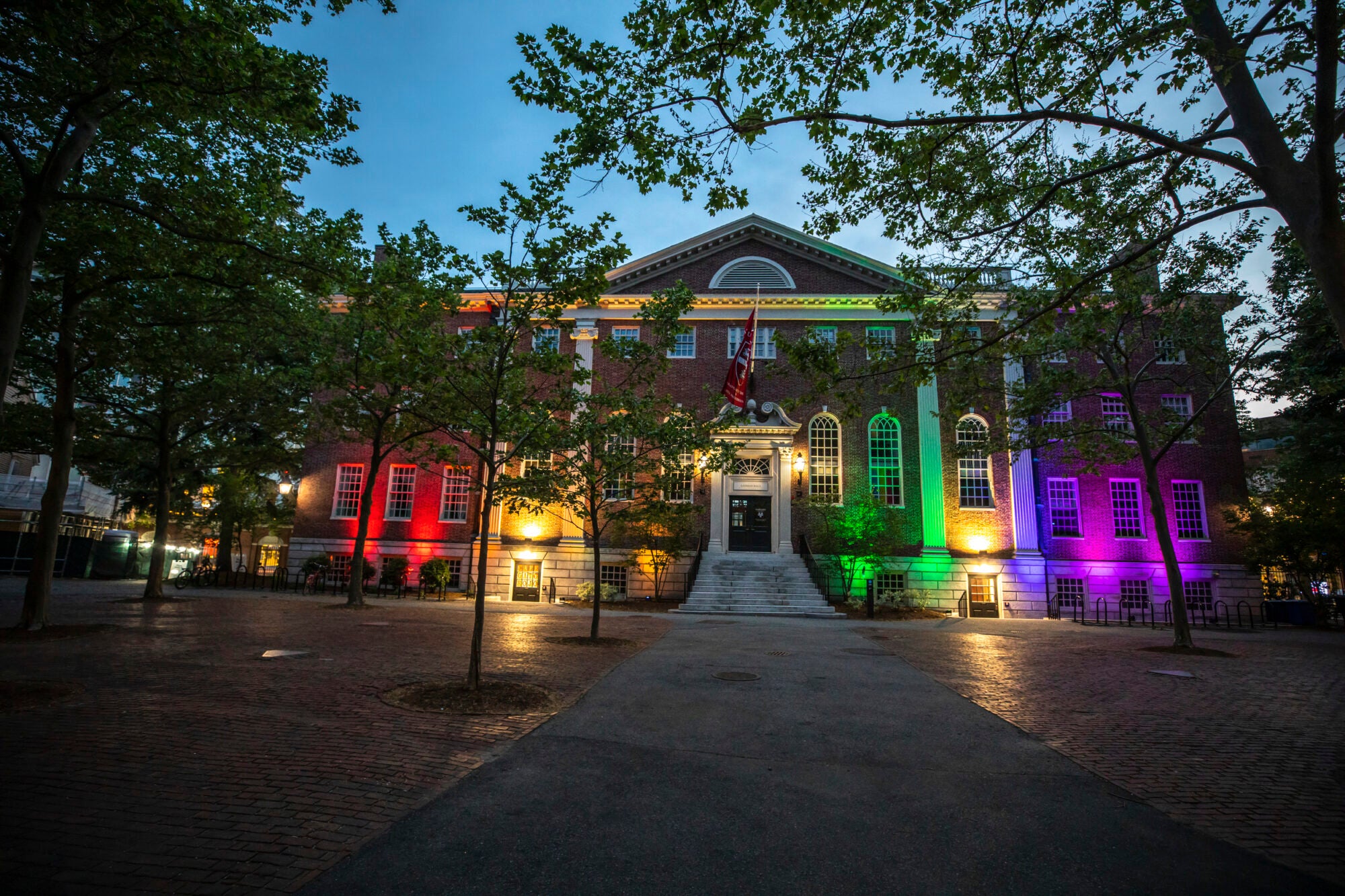 A building with rainbow color lights illuminating the front