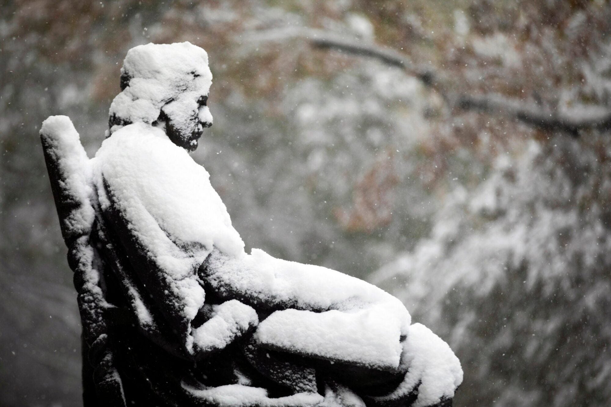 The John Harvard statue covered in snow