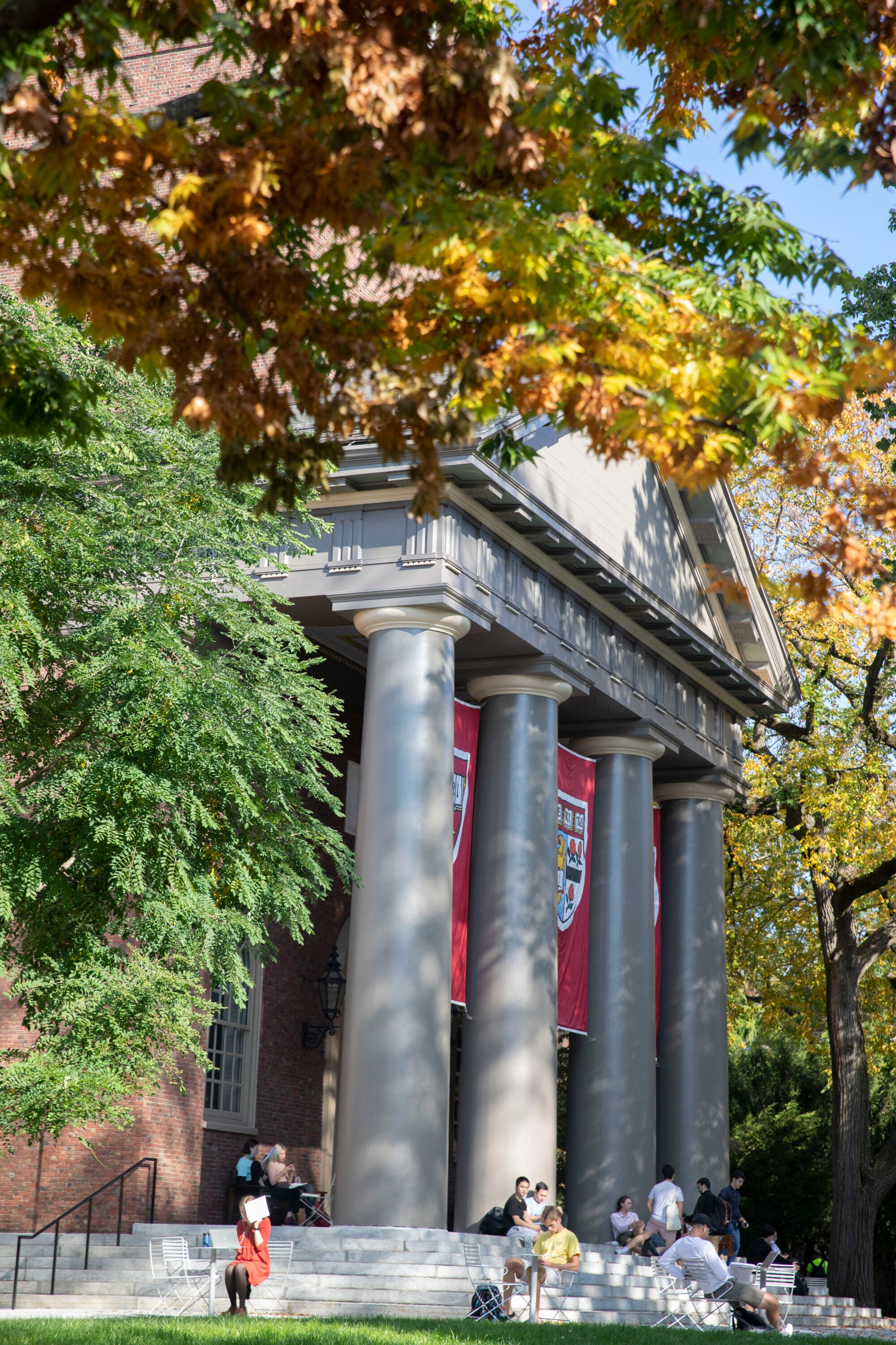 A building in Harvard Yard with columns and banners
