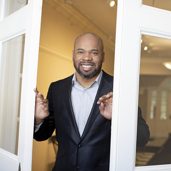 A man opens a set of double doors