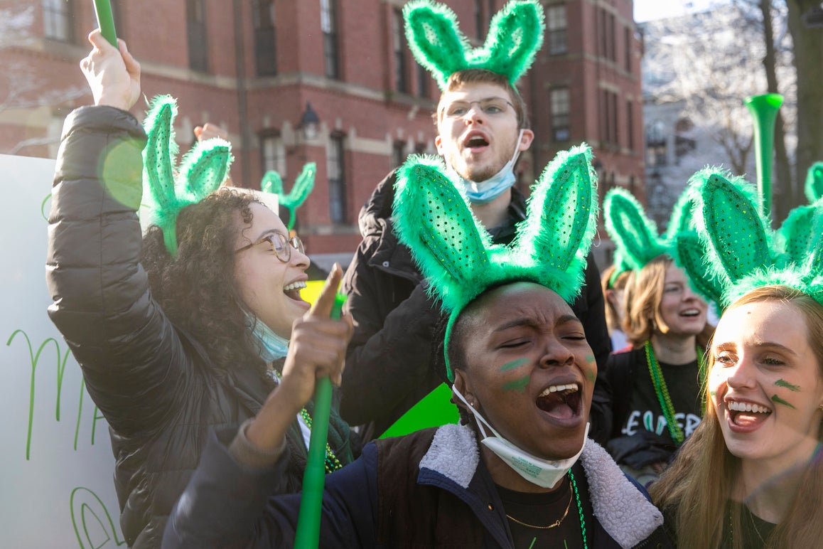 Students outside with green bunny ears