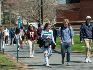 students walk through campus