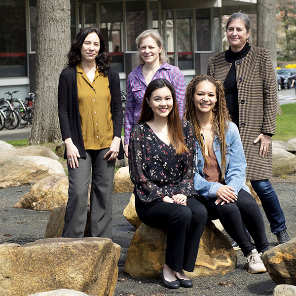 A group of five women, two students and three faculty members, outside
