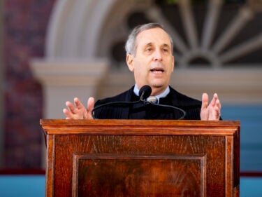 President Bacow speaks at a podium