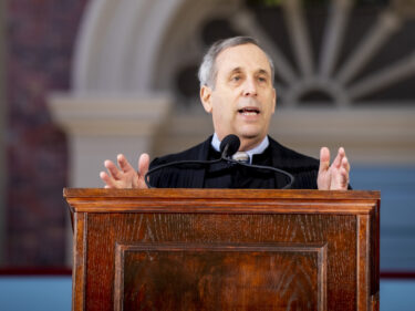 President Bacow speaks at a podium