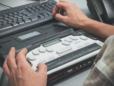 A person using an electronic braille machine