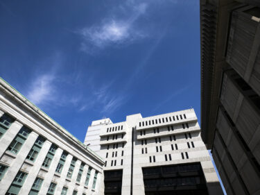 A large stone building with blue skies