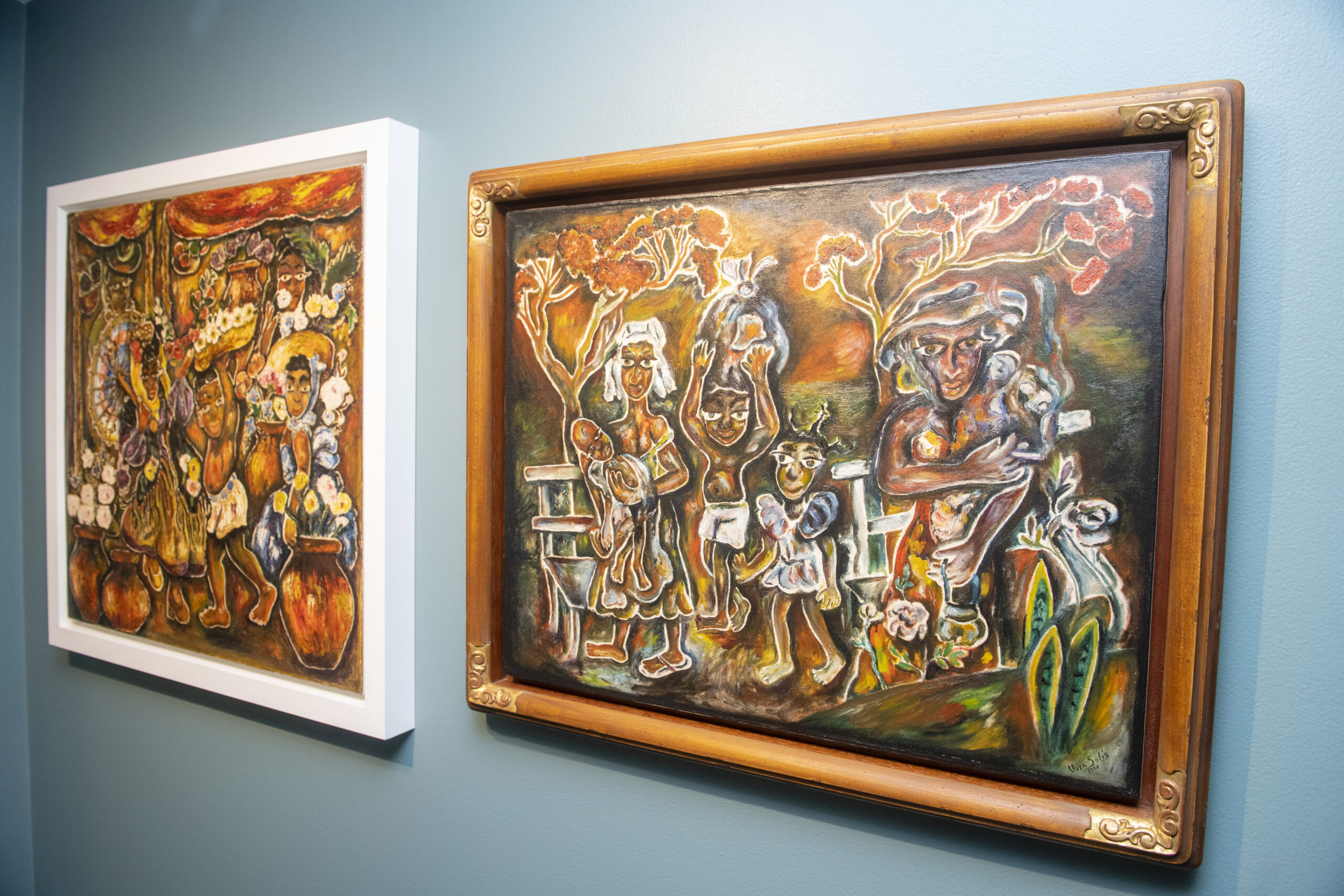 two colorful paintings on a wall