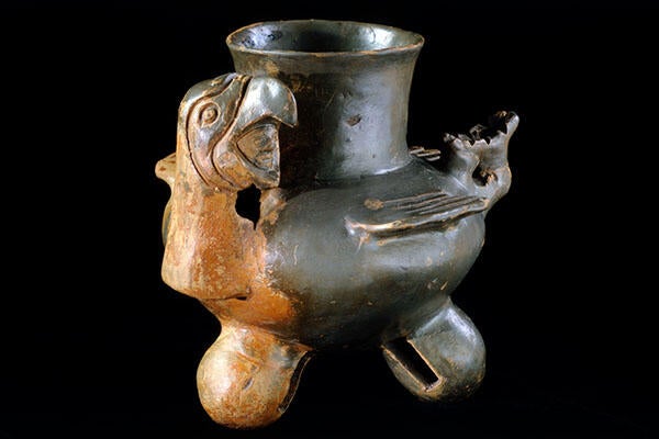 An ancient water jug with a bird on it